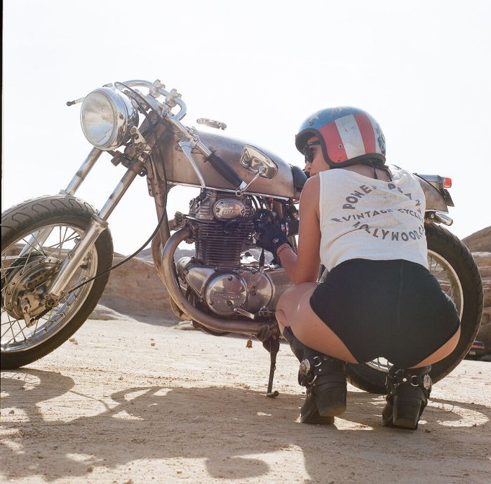 A playful frame from Girls on a motorcycle — online in Bandung
